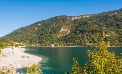 Fototapeta na wymiar Molveno lake in Dolomites, Italy. Located at the shore of Molveno lake & at the foot Brenta Dolomites group, a popular summer & winter tourists vacation resort 