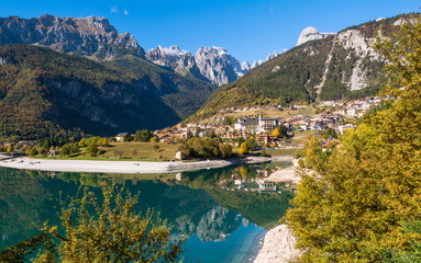 Molveno lake in Dolomites, Italy. Located at the shore of Molveno lake & at the foot Brenta Dolomites group, a popular summer & winter tourists vacation resort

