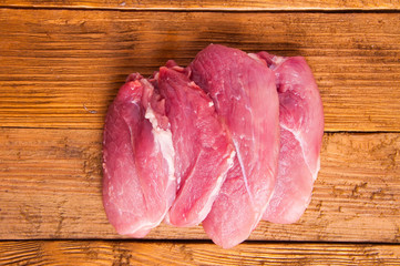 pieces of pork meat on wooden Board