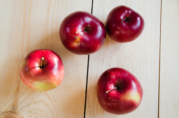 Fresh organic apples on rustic wooden background.