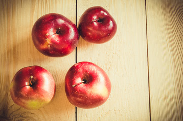 Fresh organic apples on rustic wooden background.