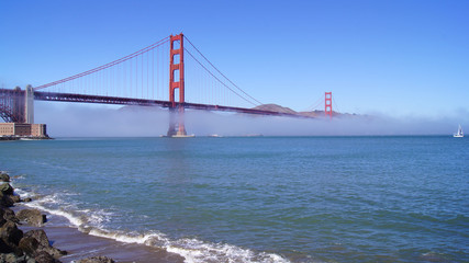 Fototapeta na wymiar SAN FRANCISCO, USA - OCTOBER 5th, 2014: Golden Gate Bridge with heavy mist or fog as seen from Fort Point-