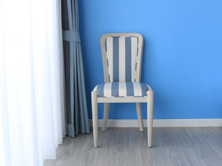 chair on wooden floor with curtain as background