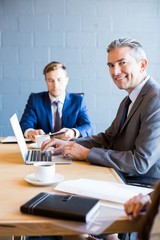 Fototapeta premium Businessman working on laptop in a meeting