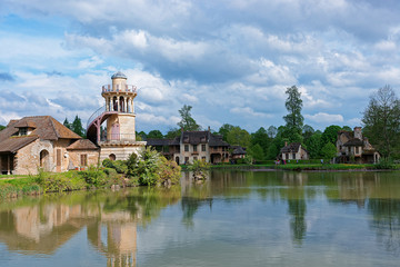 Fototapeta na wymiar Lighthouse and lake of Old village of Marie Antoinette Versailles