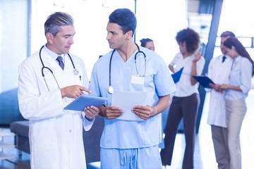 Doctor examining medical report and having a discussion