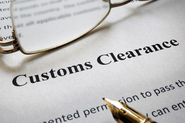 Page of paper with words Customs Clearance and glasses. - obrazy, fototapety, plakaty