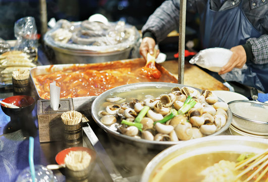 Person selling food at Myeongdong open street market in Seoul