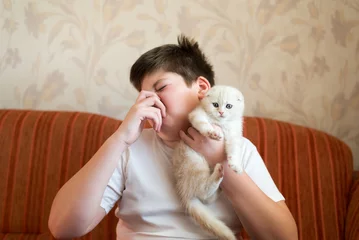 Foto op Canvas Teen turns due to unpleasant odor from cat © olgavolodina