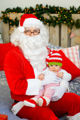 little baby in the arms of Santa Claus