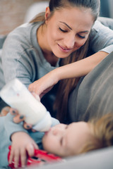 Obraz na płótnie Canvas Mom feeding her baby boy