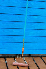 Painting of blue wall with paint roller