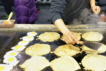 Stall with pancakes at Myeongdong street market in Seoul