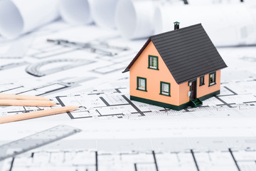 Construction plans with drawing tools and House Miniature on blu