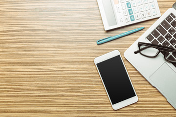 Office table with  smartphone on it. View from above