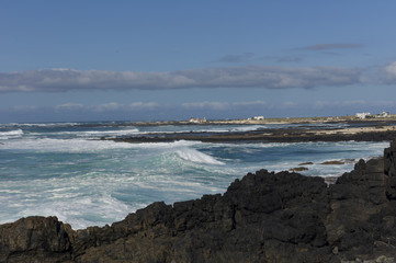 Cliff coast on the Atlantic ocean with waves rolling in.
