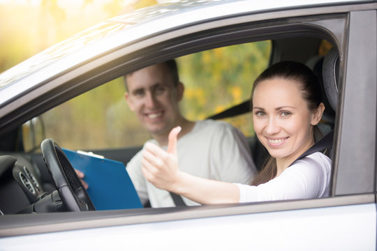 Lifestyle portrait of young happy confident lady have just finished drivers education class, showing thumb up, experienced casual instructor, holding a file folder is smiling too