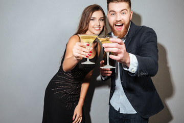 Friends with champagne looking at camera