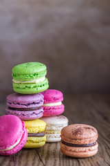 Colorful macarons on the wooden background