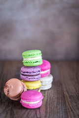 Colorful macarons on the wooden background