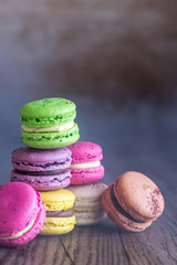 Colorful macarons on the wooden background