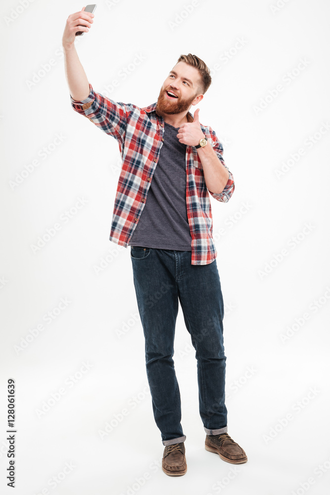 Wall mural man taking selfie and showing thumbs up gesture - Wall murals