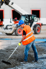 Fototapeta premium Manual worker leveling concrete