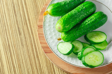 cucumbers on wooden background