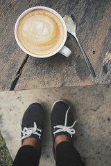 Selfie of shoes with coffee cup