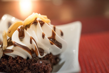 Decorated chocolate brownies with sliced almond and vanilla ice
