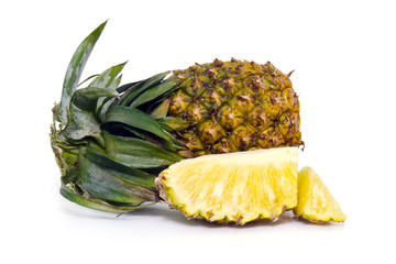 Fresh pineapple fruit with sliced pieces isolated on white