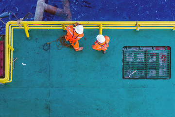 Offshore workers having a discussion prior to anchor handling activity at a bow of a construction...