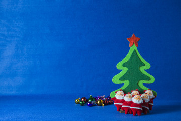 Merry Christmas and Happy New Year concept,Christmas tree with Santa Claus,blue background.