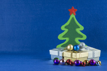 Merry Christmas and Happy New Year concept,Christmas tree with gift box,blue background.