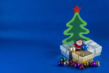 Merry Christmas and Happy New Year concept,Christmas tree with Santa Claus,blue background.