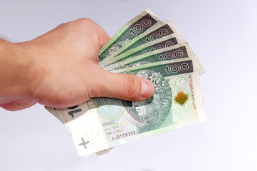 people, business, finances and money concept - close up of businessman hands holding polish money zloty (pln), paying