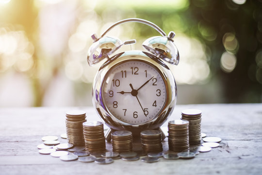 Close up of time and money with green bokeh background ,Business