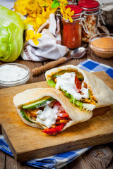 Fried chicken meat with vegetables in pita bread