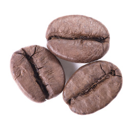 Top view of three coffee beans, isolated on white background