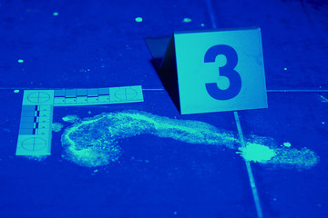 Foot print developed by black light in bathroom