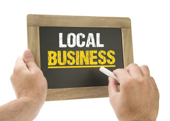 Local Business / Hand schreibt auf Kreidetafel