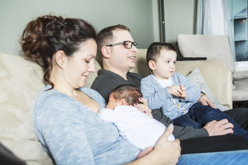 Obraz premium Young happy family with two children at home