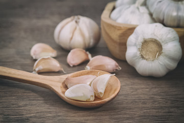 Sliced garlic ,garlic cloves on wooden vintage background.
