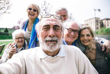 Group of senior looking in camera for a portrait.  Funny selfie of a group of old friends  - obrazy, fototapety, plakaty