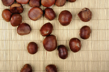 raw chestnuts on bamboo napkin 