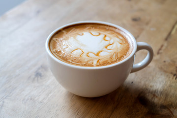 Caramel latte cup on wooden table 