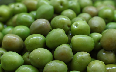 Green whole olives close up background