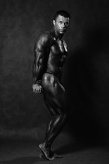Muscular male Bodybuilder posing in studio