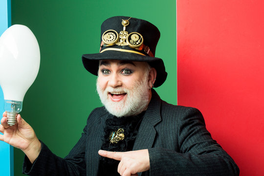 smiling man holds light bulb