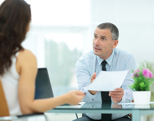 insurance agent shows the contract to the client in the office b